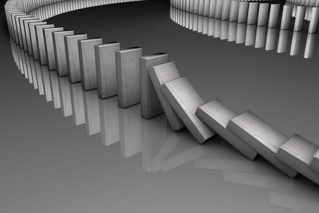 domino pieces falling - system integration failures analogy